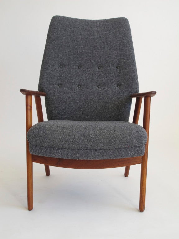 Hans Olsen designed highback easy chair newly upholstered in high-quality wool textile with leather buttons.