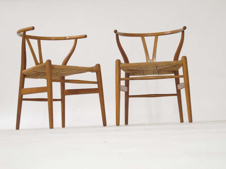 Set of six first-production white oak wishbone chairs designed by Hans Wegner and produced by Carl Hansen & Son in 1950. Original condition, stamped with the first burn mark of Carl Hansen & Son, Danmark.