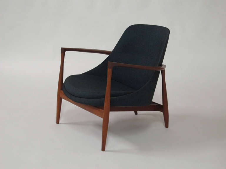 IB Kofod Larsen lounge chair, model U-56, ' Elisabeth', with teak frame, seat and back upholstered in original teal wool fabric. Presented at the Copenhagen Cabinetmakers Guild exhibition at the Danish Museum of Decorative Art in 1956. Produced by