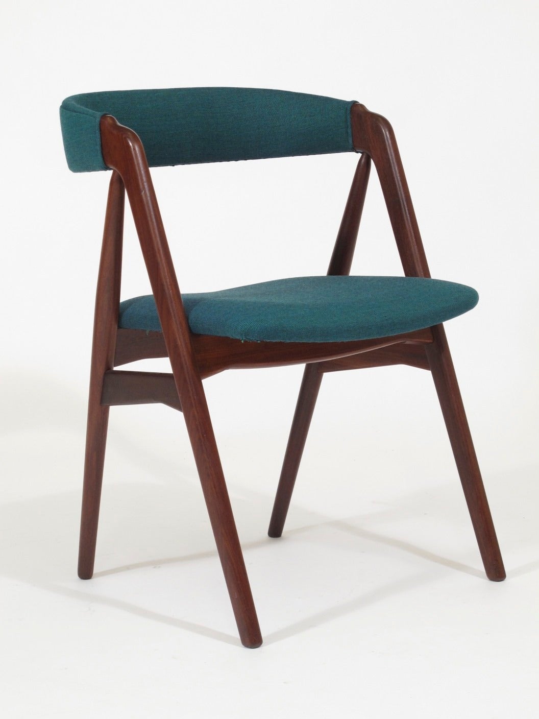 Six Mid-century walnut dining chairs in manner of Kai Kristiansen. Curved backs on A-frame with cross stretchers under seat for support. Newly upholstered in teal fabric.  Additional chairs available to create set/8+