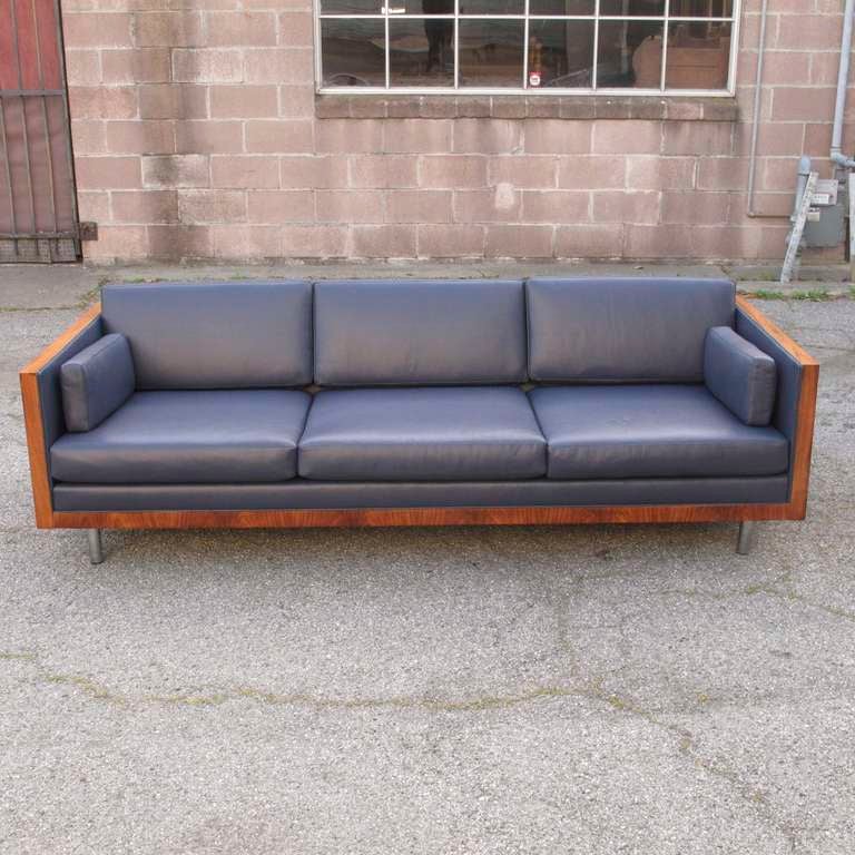 Rosewood case sofa designed by Milo Baughman. Newly  upholstered with full aniline navy blue leather. Stunning rosewood grain on sides, raised on chrome legs. 