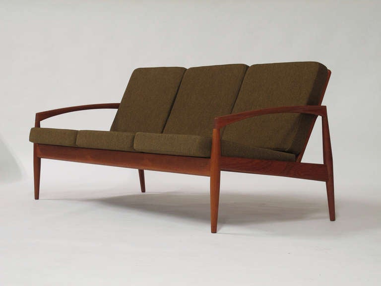 Model #121 three-seat sofa designed by Kai Kristiansen for Magnus Olesen, Solid teak frame with slat back in original wool fabric, new foam.
