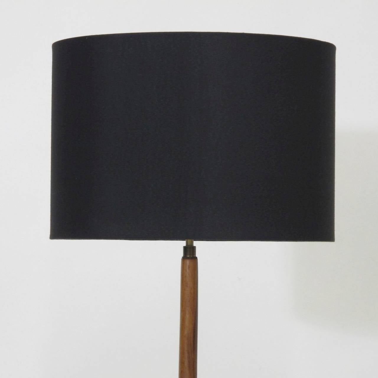 Danish floor lamp with turned Brazilian Rosewood stem with brass inlay on round base, newly rewired with black silk cord. Shown with black silk shade.
Base diameter 9.75.