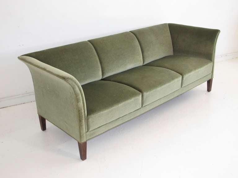 1940's three-seat sofa with dramatic flared arms in original green mohair wool velvet.