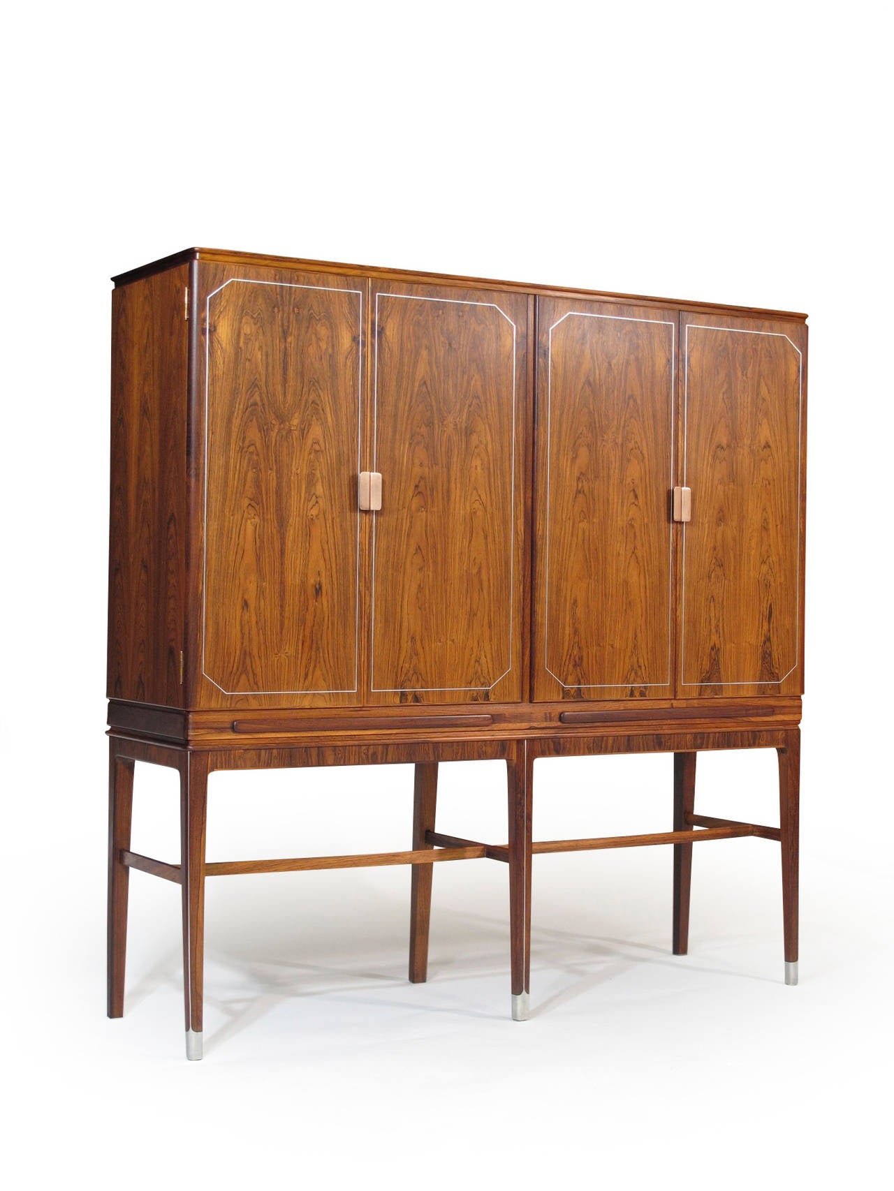 Handcrafted rosewood sideboard by master cabinetmaker Georg Kofoed. Rosewood with book matched doors with copper pulls surrounded by eight-carat white gold plate over copper inlay. Underneath the doors, two pull-out trays are released with the press
