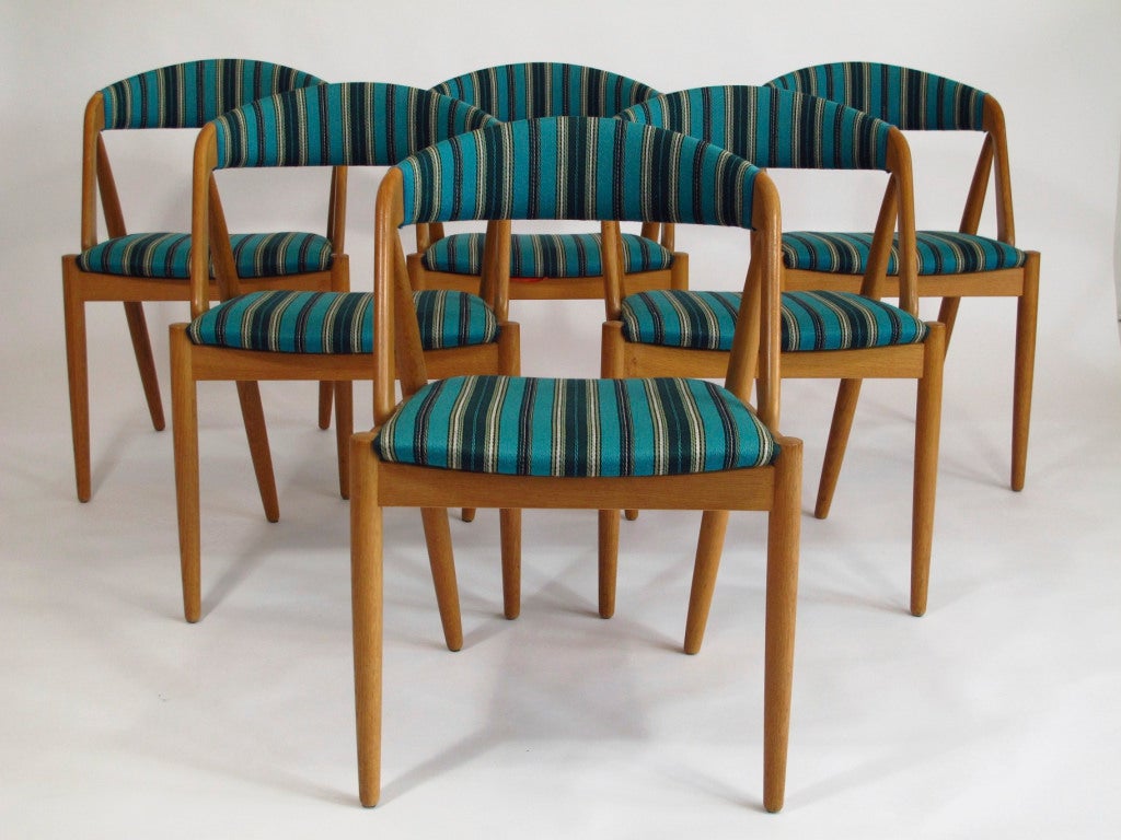 Kai Kristiansen curved back dining chairs with teal upholstery