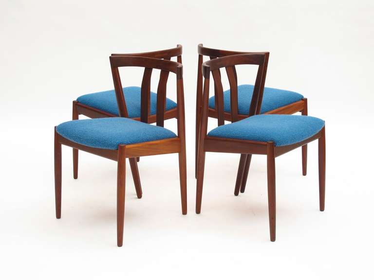 Set of four walnut dining chairs with exposed joinery on backs, newly upholstered seats in an Aegean blue boucle.