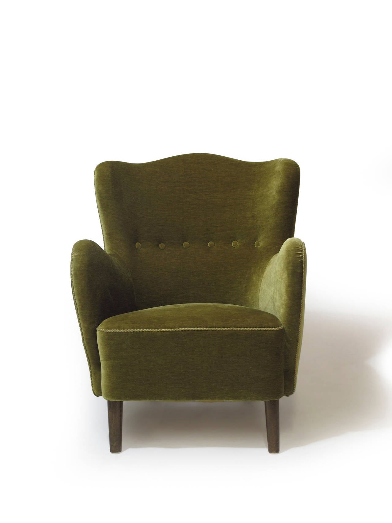 Sculptural mid century Danish lounge chairs with solid wood frame, hand tied springs, and horsehair padding. The curved back offers an excellent supportive backrest. Covered in the original olive-green mohair wool. Raised on beech legs, stained