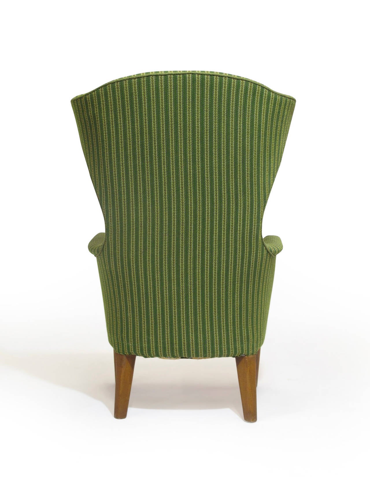 Mid-century Danish wingback chair with dramatic sculptural form. Hand crafted with a solid wood frame, eight-way hand tied springs and horsehair padding. Covered in the original woven green fabric. Raised on oak legs with amber shellac finish.