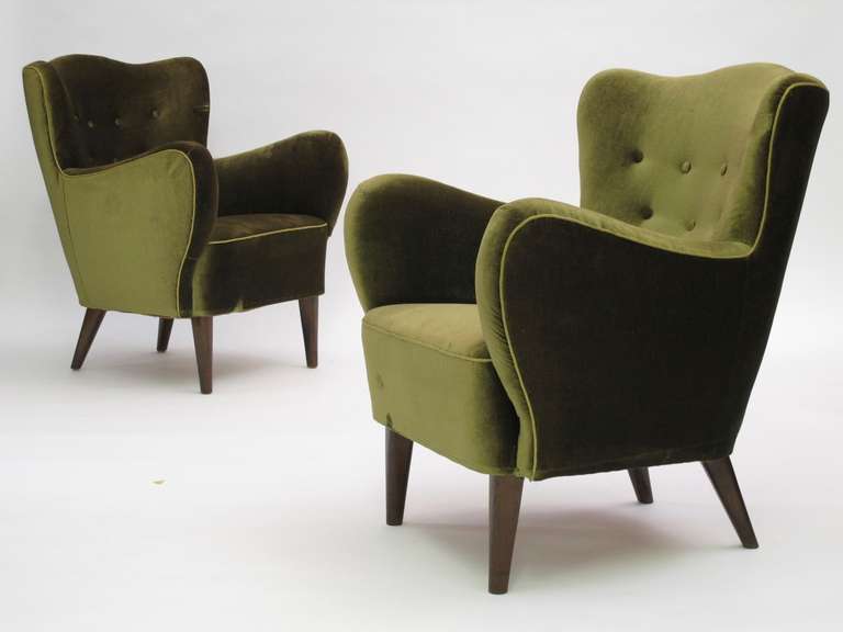 Sculptural 1940's Scandinavian lounge chairs with solid wood frame, hand tied springs, and horsehair padding in original olive-green mohair wool fabric. The curved backs are very comfortable seating.
