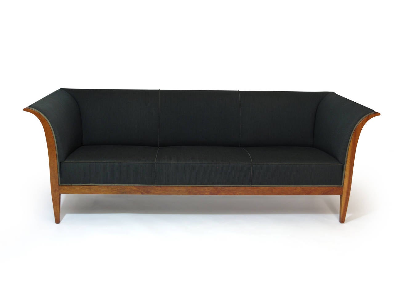 Elegant sofa by master cabinetmaker Frits Henningsen. Flared arms of Cuban mahogany, upholstered in the original wool fabric with horsehair padding.
