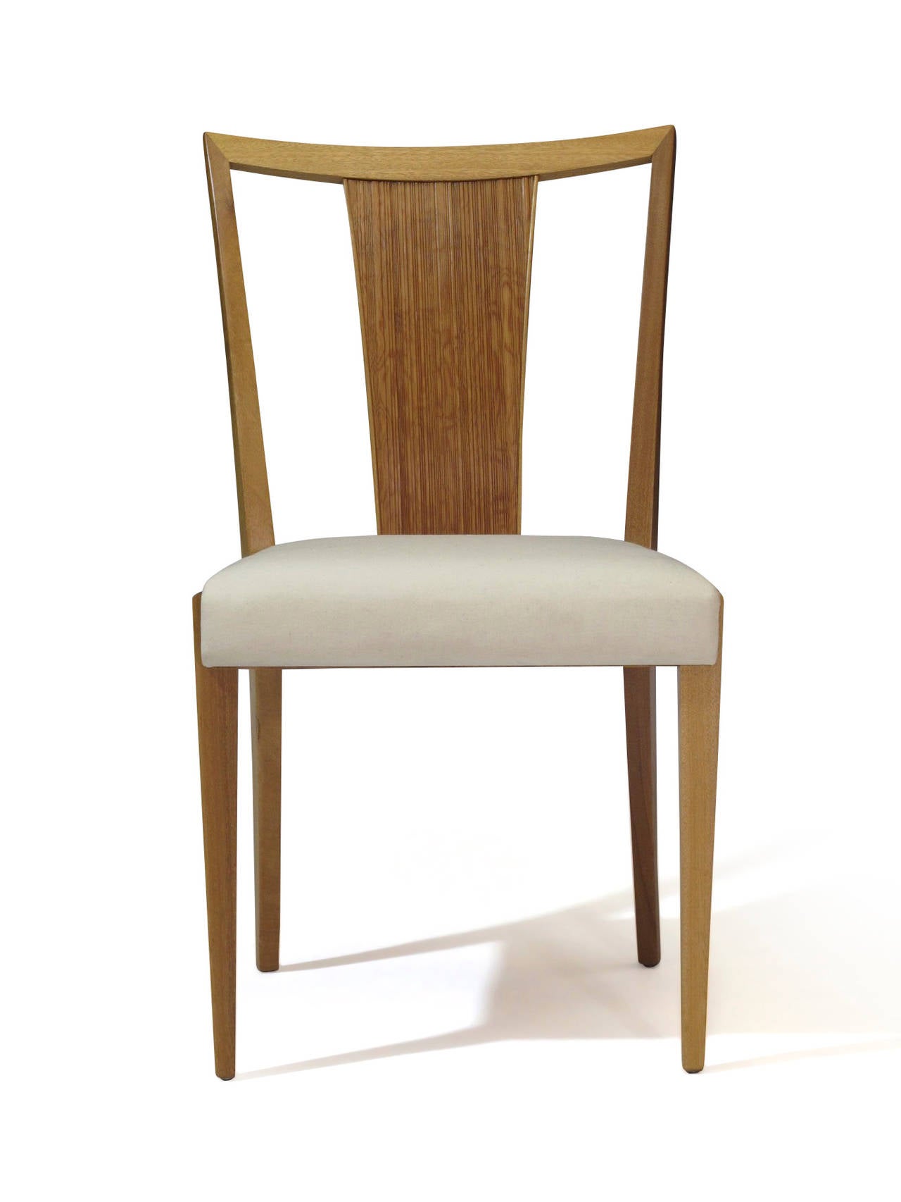 Six dining chairs designed by Paul Frankl for Brown Saltman. Blonde mahogany frame with combed fir back rest. Seats upholstered in muslin. Dining table available upon request.