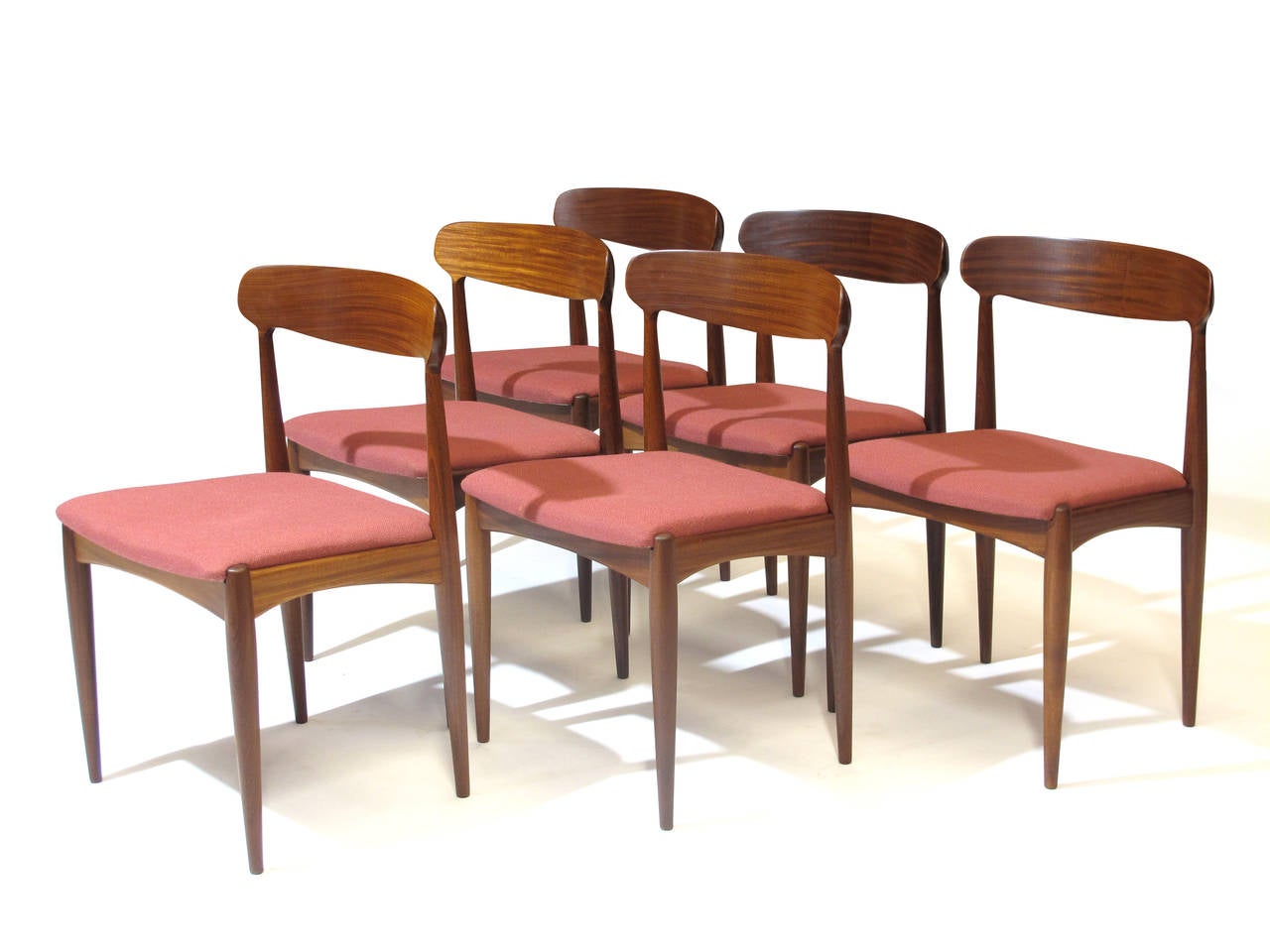 Six Mid-Century dining chairs designed by Johannes Andersen with beautifully grained, solid wood curved backs and original wool seats.