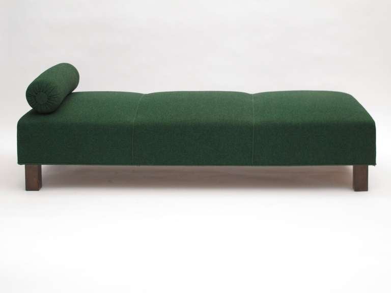 Mid-Century Danish daybed upholstered in the original green wool fabric. Solid construction with eight-way hand tied springs, horsehair and cotton padding raised on squared stained walnut legs.