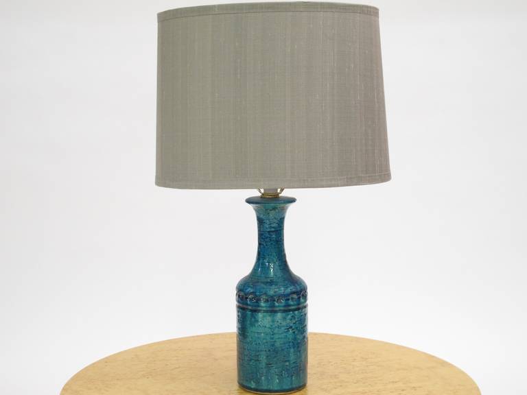 Ceramic lamp with aqua and green glaze newly rewired with black silk cord. Includes grey silk shade. Base diameter is 4.25.