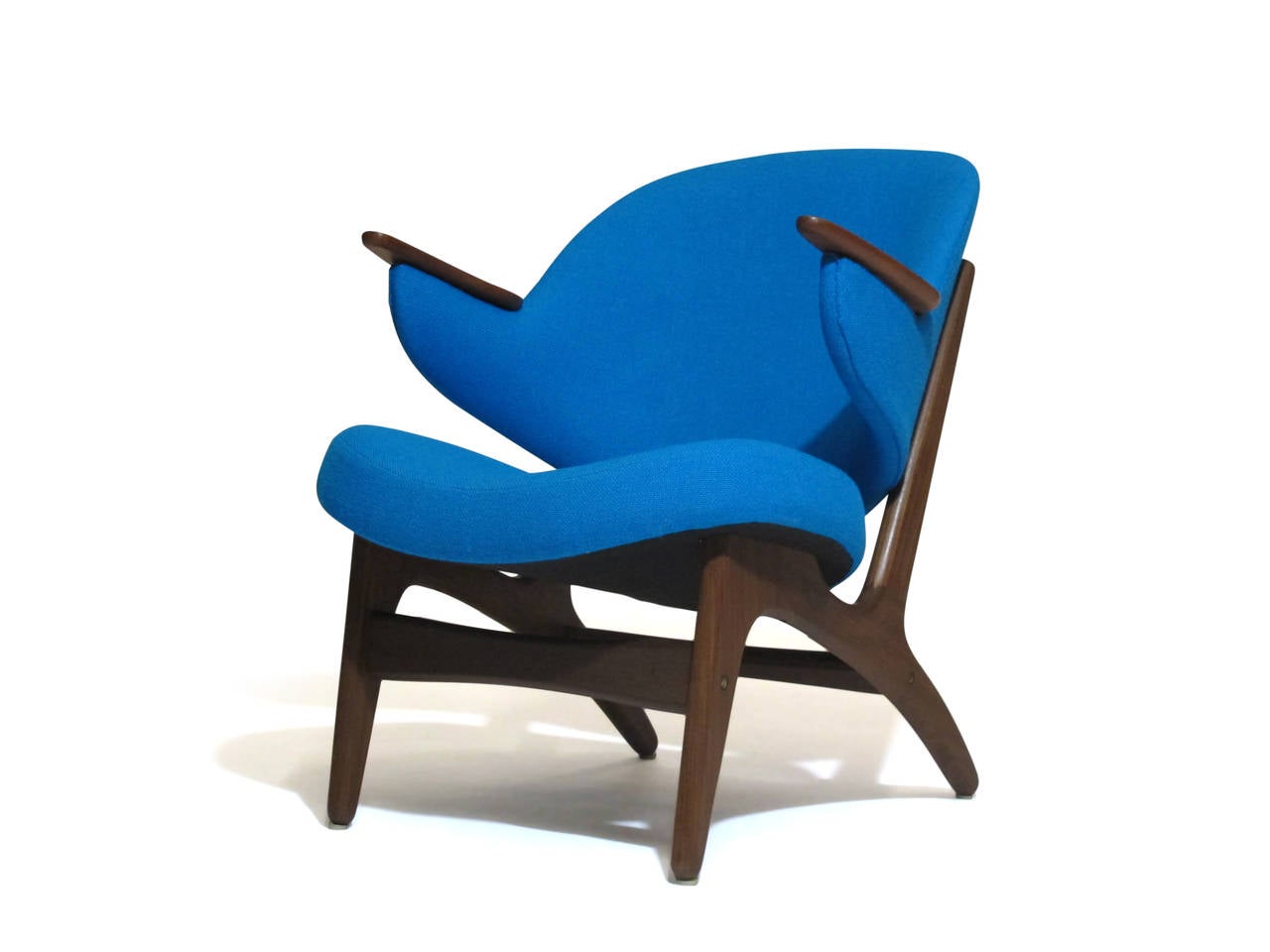 Sculptured Danish lounge chair with comfortable curved back rest on walnut frame with teak arms. Newly upholstered in an aqua blue wool textile. Fabric sample available upon request.