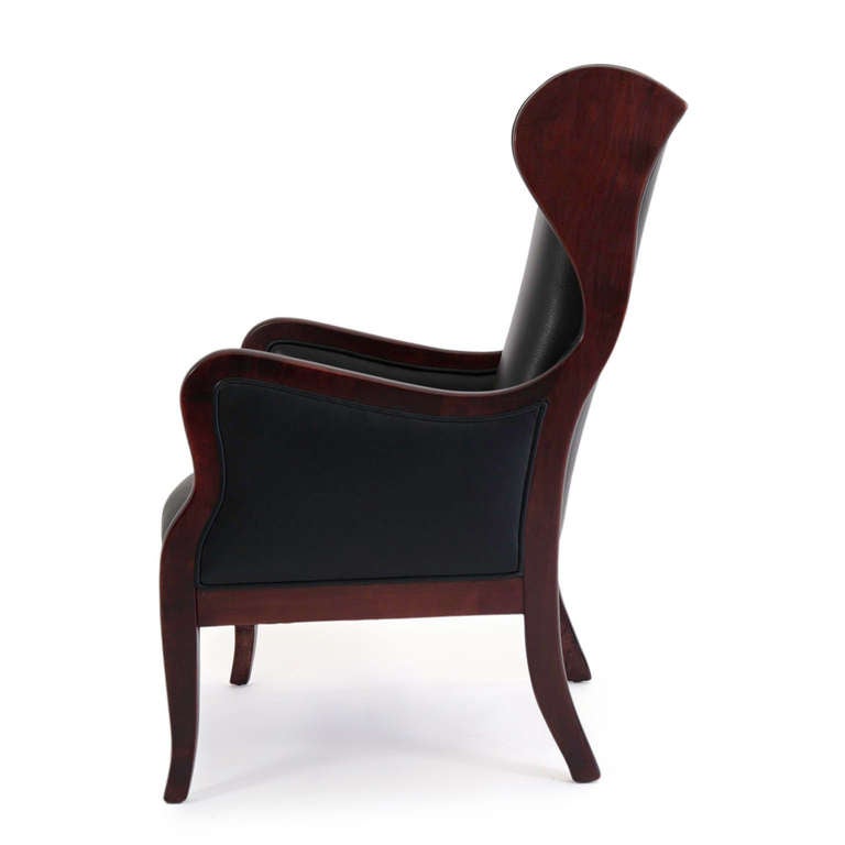 1940s mahogany wingback chair produced by cabinetmaker Frits Henningsen, Denmark. Elegant form with new high-quality black leather. Hand-tied springs and horsehair padding.