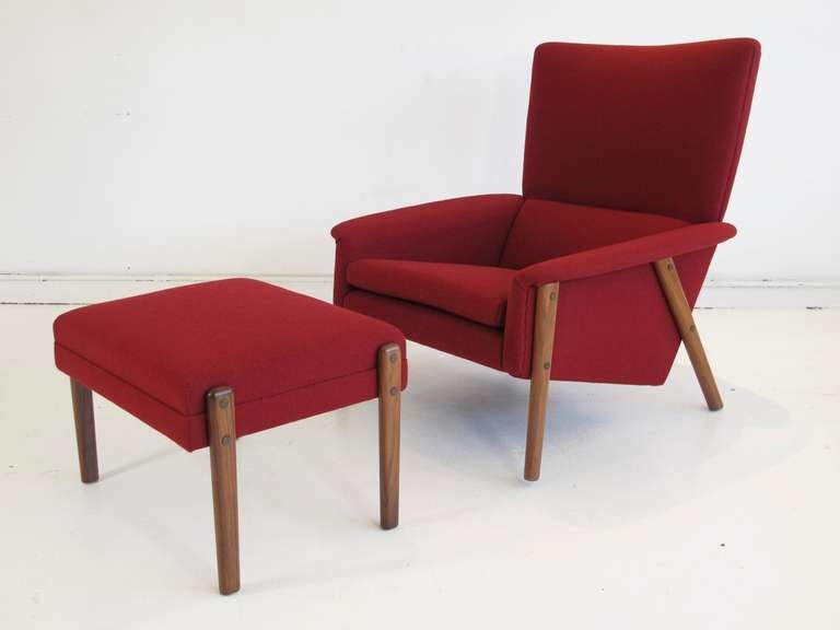 Dramatic high-back lounge chair designed by Folke Ohlsson for Dux. Newly upholstered with red/burgundy wool fabric over a wooden frame with rubber back supports and natural latex foam. This combination of construction techniques and materials