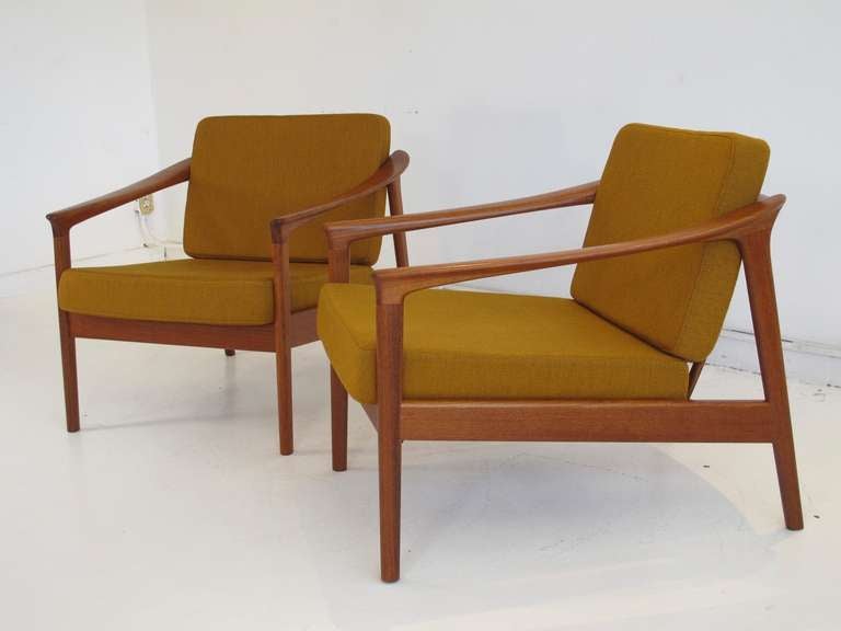 Pair of teak frame lounge chairs designed by Folke Ohlsson for Bodafors, Sweden 1963. Curved armrests with spoke back and  cushions with original mustard yellow wool upholstery supported by series of new rubber straps. Comfortable seating. Signed.