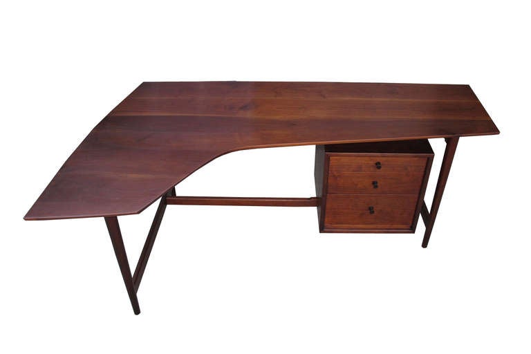 Richard Artschwager, mostly known as an American Minimalist pop-art painter and sculpture, designed and manufactured modern furniture in 1953. This bench-made, limited production desk is handcrafted of solid black walnut and features a unique form