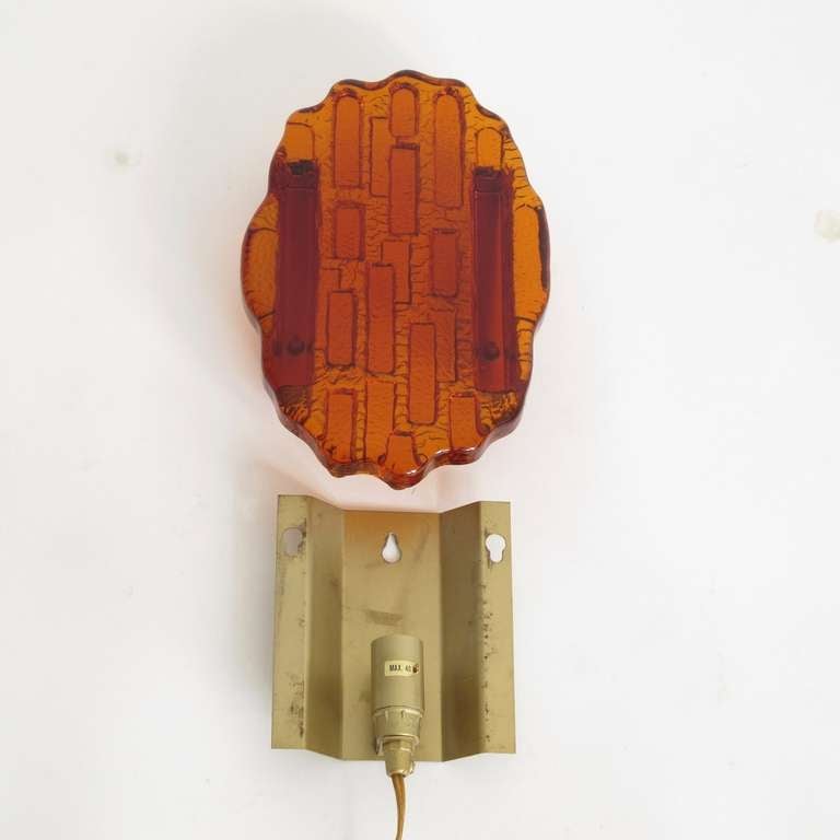 Pair of abstract wall sconces composed of rich colored orange glass. Newly rewired.