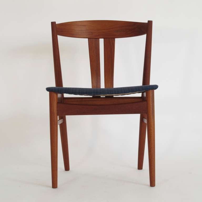 Set of six Danish teak dining chairs with elegant curved backs with pair of vertical slats, original navy blue fabric seats. Stamped with manufacturers mark. Custom upholstery options available.