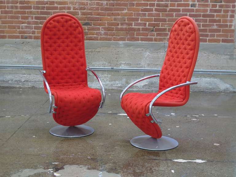 Pair of high-back cantilevered lounge chairs designed by Verner Panton for Fritz Hansen; tufted upholstery in original red wood textile on aluminum base with chrome plated steel arms.