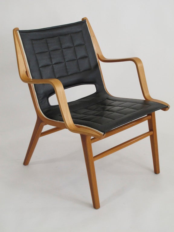 Ax-chair designed by Peter Hvidt & Orla Molgaard Neielsen for Fritz Hansen.  Laminated beech bent-wood and teak frame. Newly upholstered top-grain black leather with grid stitching over canvas.