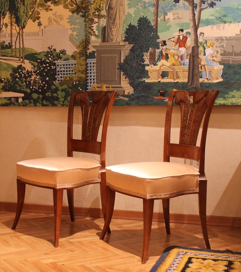 A pair of Italian solid walnut wood chairs with Windsor feathers back and graceful curved legs is very sophisticated, these side chairs are just a delight and are a perfect against a wall or standing on their own. Newly upholster with light rose