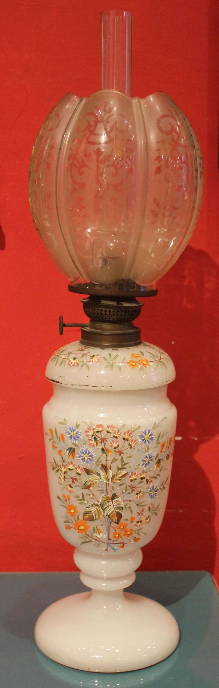 Early 20th century hand-painted glass oil lamps with original crystal shades.