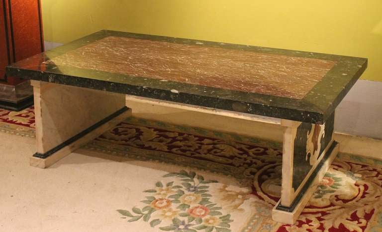 This Florentine early 20th Century rectangular low coffe table expresses all Italian mastery in marble's selection and crafting. This solid marble table is made of precious White Carrara marble, a rich Green of the Italian Alps and a deep French red