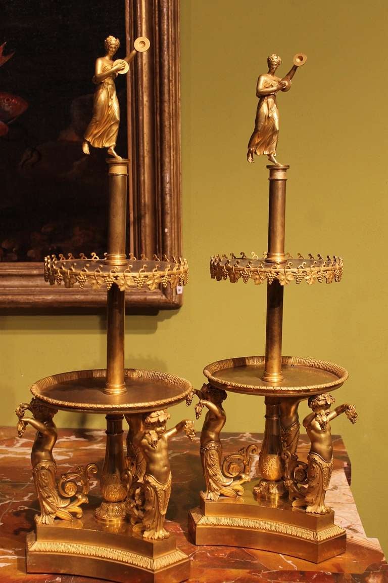 Paris, Empire Period
An outstanding pair of ormolu two-tier stands, decorated with vine leaves and grape. Three putti on the triangular base support the level above and a finely engraved pompeian dancer complete the composition. Manufactured by
