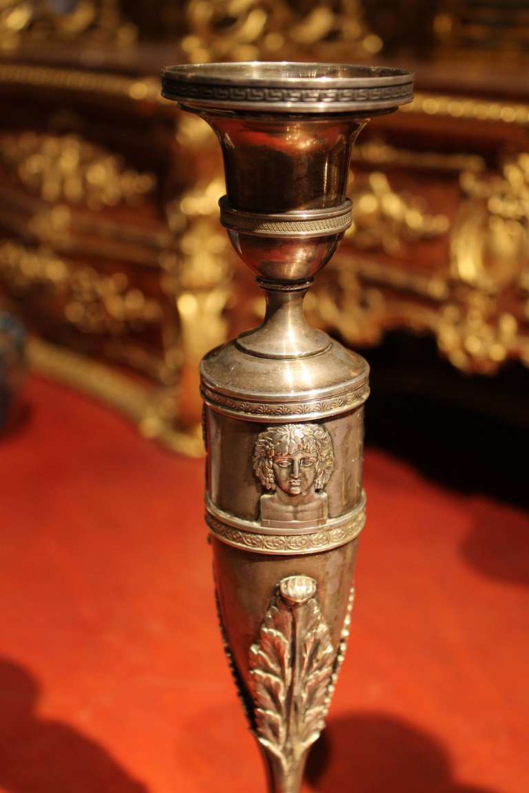 This very fine pair of antique German silver candleholders date back to Empire period. They are finely decorated with classicistic patterns. These exquisitely candlesticks have a removable drip tray incised with Greek key strip and a finely chiseled