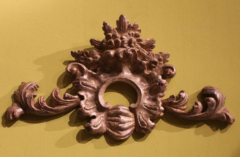 This original late 19th Century hand carved wood frieze is a typical Florentine work of art. It has a curvy shape featuring scrolls, floral patterns an centered by a shell. It's finely inlaid and has a gorgeous silver color! It can be used as a