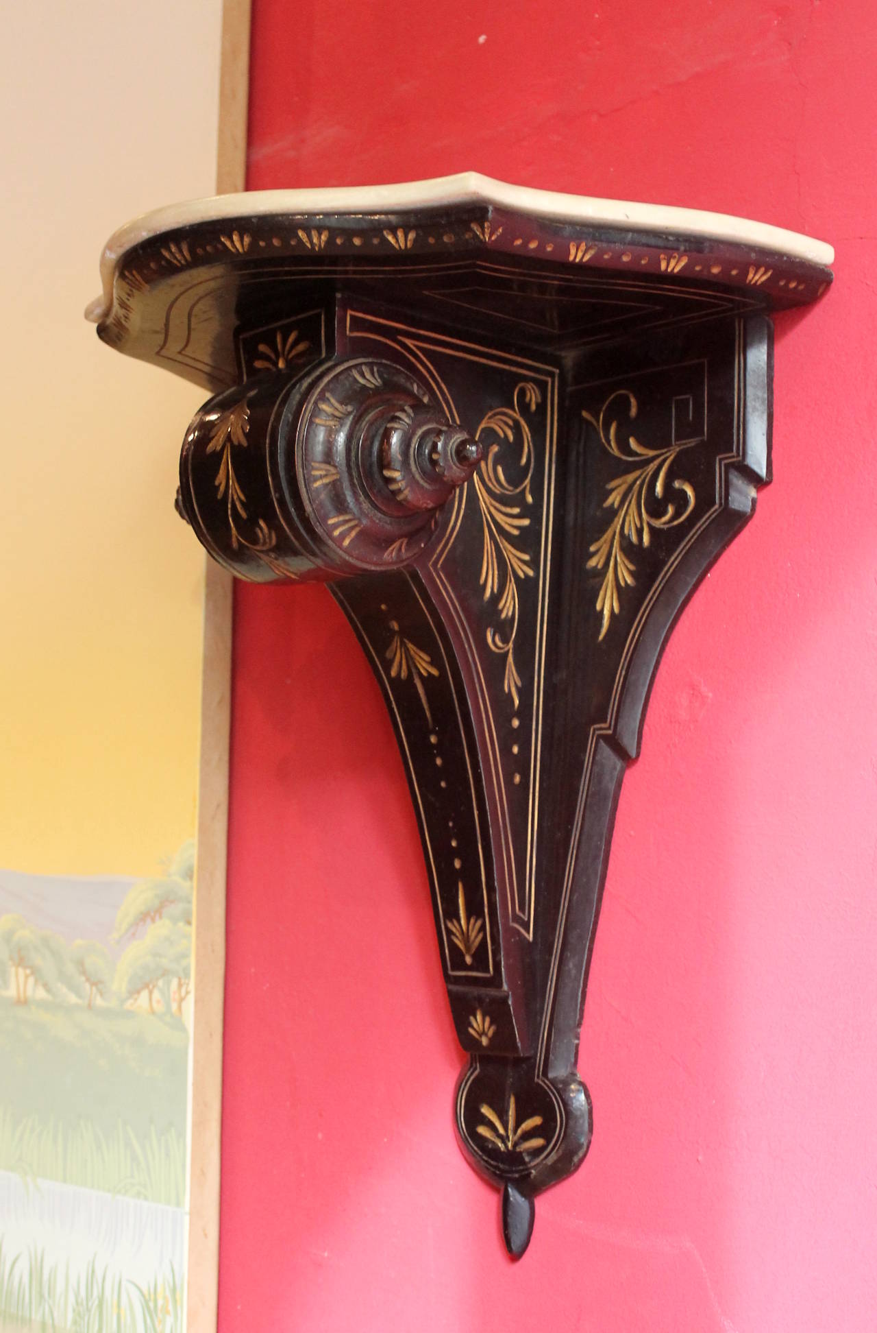 A highly decorative 19th century pair of Neogothic revival ebonized wall bracket of exceptionally fine quality. The shelves are made of ebonized black intricately carved wood moulding with an egg and dart design featuring a scroll shape. They are