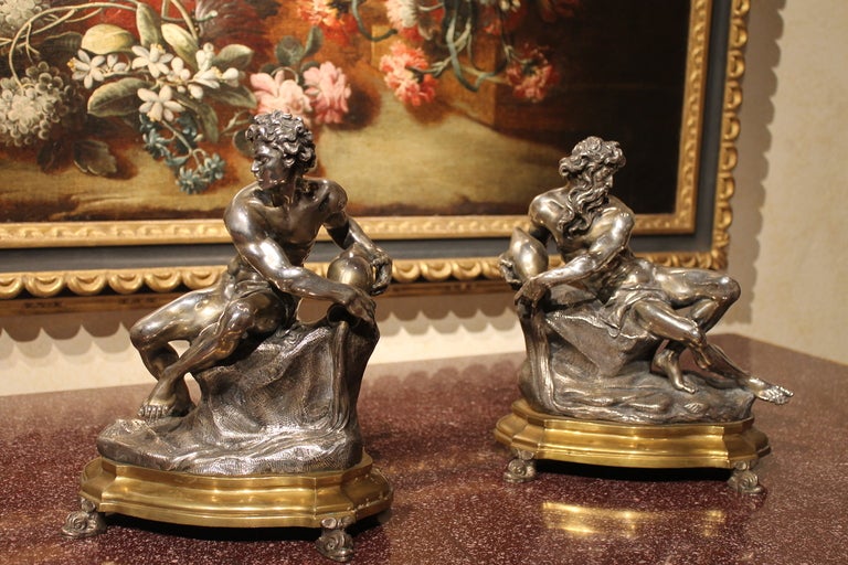 Rome, late 19th - early 20th century 
A very beautiful pair of silver sculptures with mercury gilt bronze bases carved in the manner of Gian Lorenzo Bernini’s rivers Gods statues. 
The statuettes depict  two rivers Gods reclining on a rock whilst