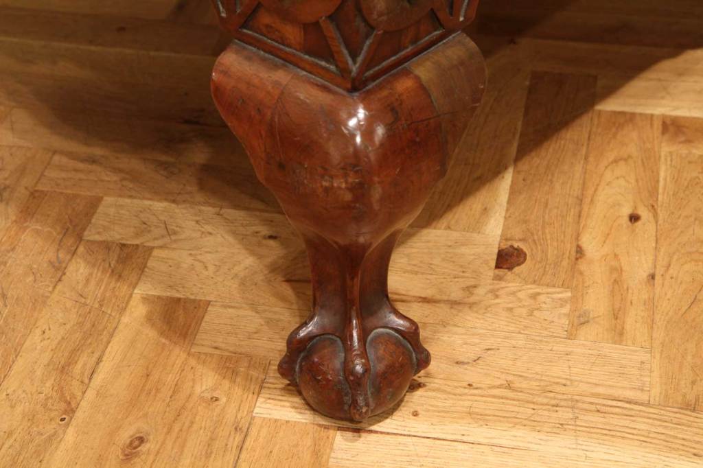A stunning and original Chippendale style English 18th century honey and brown burr walnut veneer travelling dome top trunk beautifully carved and inlay, enriched with gilded and burnished bronze details centered by a brass high relief medallion.