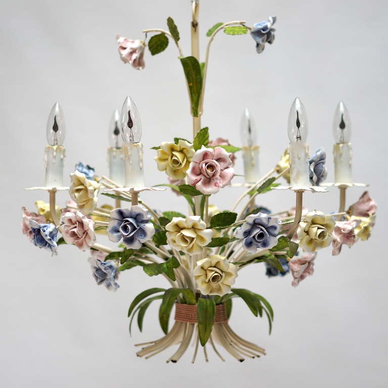 This is a very beautiful painted metal chandelier. The whole piece is adorned with porcelain flowers. 
Diameter:62 cm.
Height:60 cm.