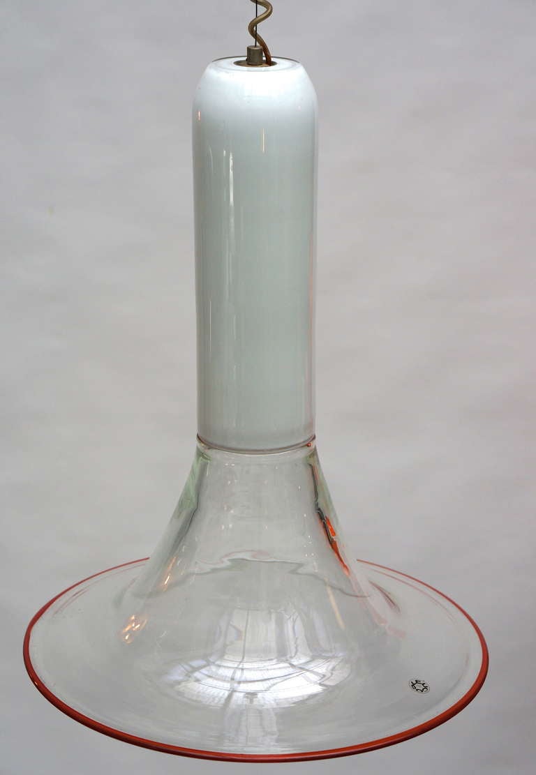 Heavy handblown glass pendant by Roberto Pamio & Renato Toso for Leucos, Italy, circa 1969-1970. The bulb is up in the long white tube. Clear trumpet is bordered in red. Cable wire in long curly cord.
Diameter:45 cm.
Height:60 cm.