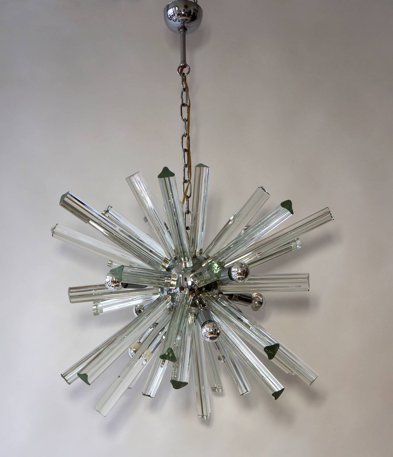 A Mid-Century Modernist chandelier feature a sputnik design, numerous Murano glass triedre shaped rods emanating from a chrome spherical centre, it has nine European based bulbs (max 75 watts per bulb)
The hanging height can be adjusted to suit