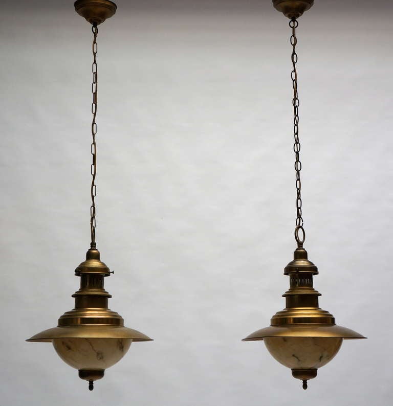 A pair of brass chandeliers.
Total height 130 cm.