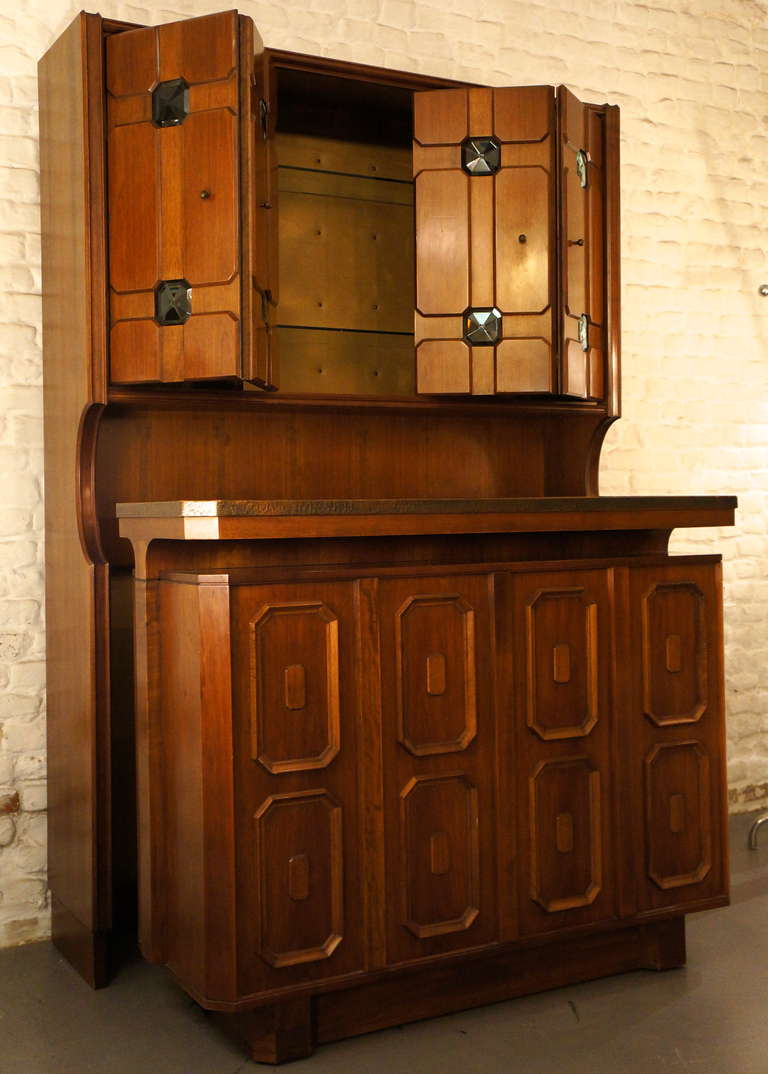 The buffet is mobile and can be driven in the wall unit. The bar has a beautiful copper countertop installed. The cabinets of the wall unit is equipped with lights and the refrigerator. 
This lovely piece of furniture is derived from Rome, Italy.