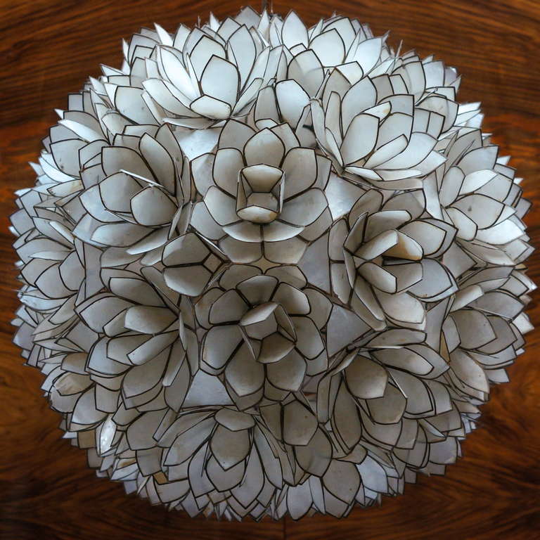 Beautiful flower form chandelier by Belgian designer Willy Daro with capiz shell flowers. The light represents the attempt of the designer Willy Daro to bring art and sculpture into home design. Unique and interesting, this light is a statement