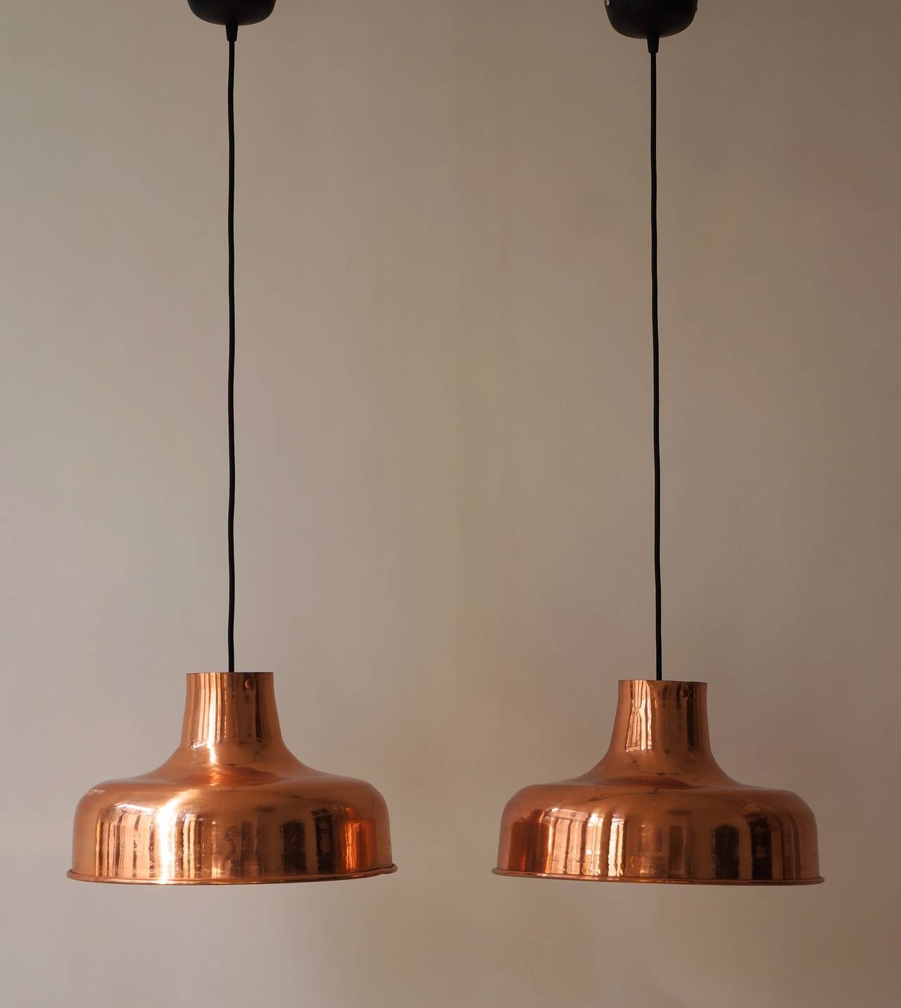 Vintage copper pendant lights with new electric wiring.