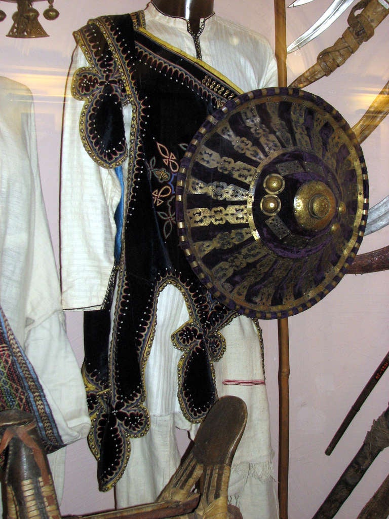 Ethiopia,
1900
leather, wood, probably made from giraffe, gazelle, antelope or rhinoceros skin, stretched with purple velvet and decorated with punched metal sheet ornaments, back and handle stretched with red leather, min. dam., slight signs of