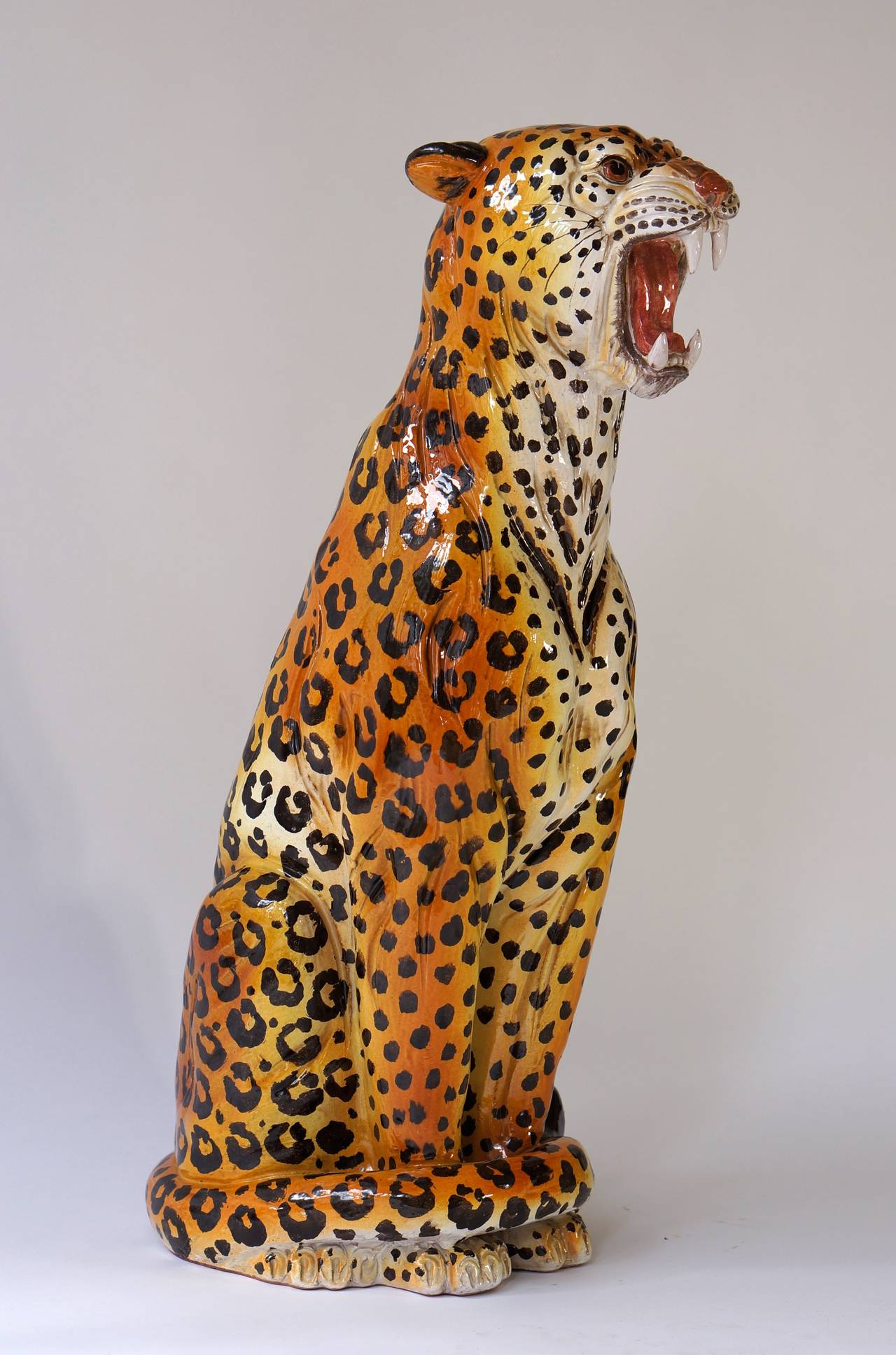 Italian vintage cheetah sculpture in polychrome ceramic. The life-like pose and expression are captivating.