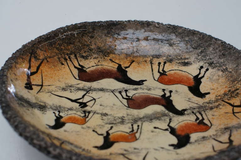 A nice bowl or cigar ashtray by the French artist Andre Guiron executed in Vallauris. It features Lascaux cave painting figures. Signed. In good condition 

Measure: Diameter 35 cm.