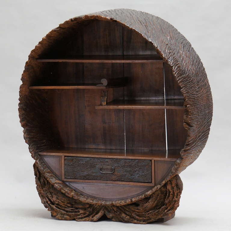 An unusual Japanese round display cabinet, made of a hollow tree trunk;