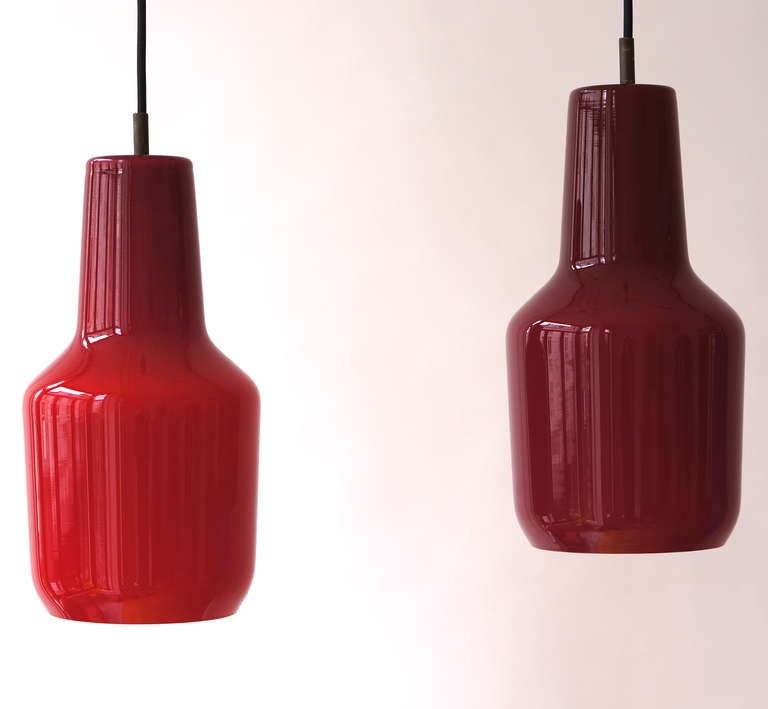 Very nice shaped glass pendant lamps designed by Massimo Vignelli for Venini, Murano 1960. This heavy and thick glass lamp has a very nice unusual shape. The lamp gives very nice warm light when lit.