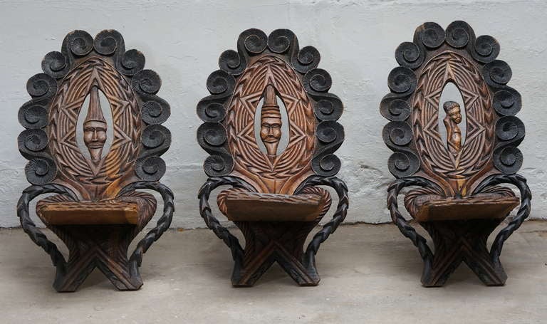 Three wooden African chairs from Congo.